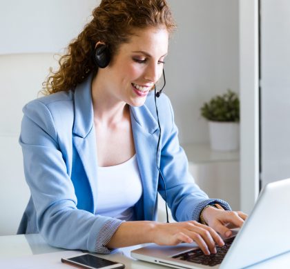 Customer service operator talking on phone in the office. Portrait of customer service operator talking on phone in the office.